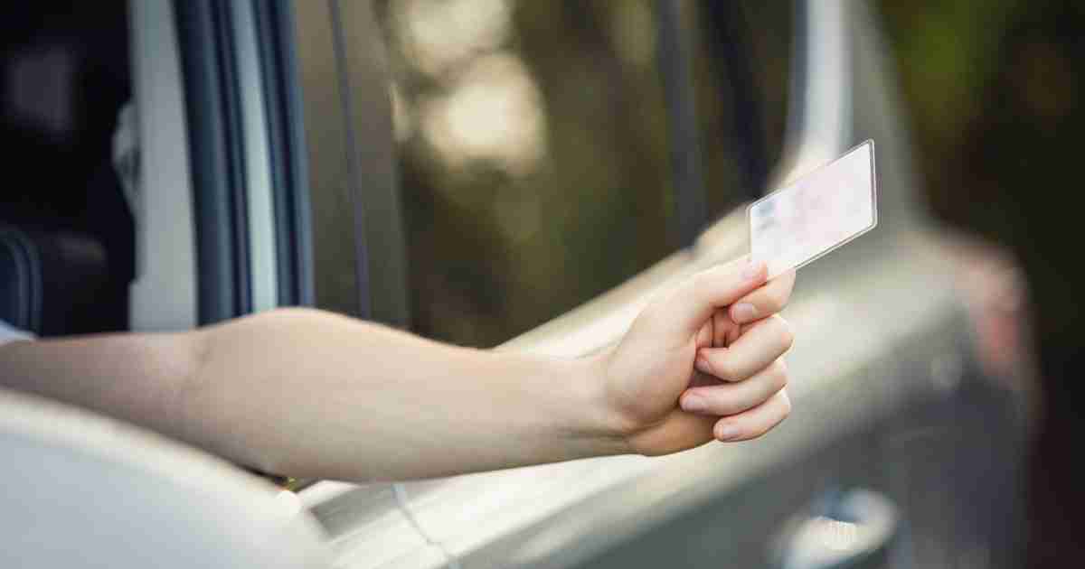 Person handing a license out of a window. 