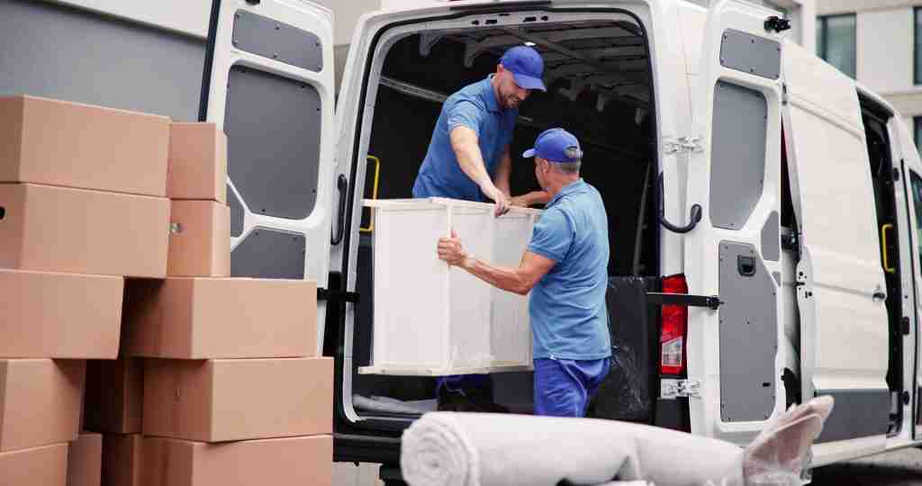 Millersport movers loading furniture into the back of a truck