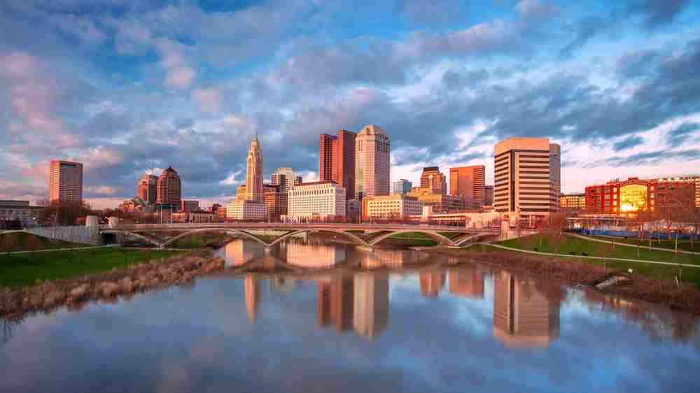 Ohio city at sunset with a bridge over the river running through the city