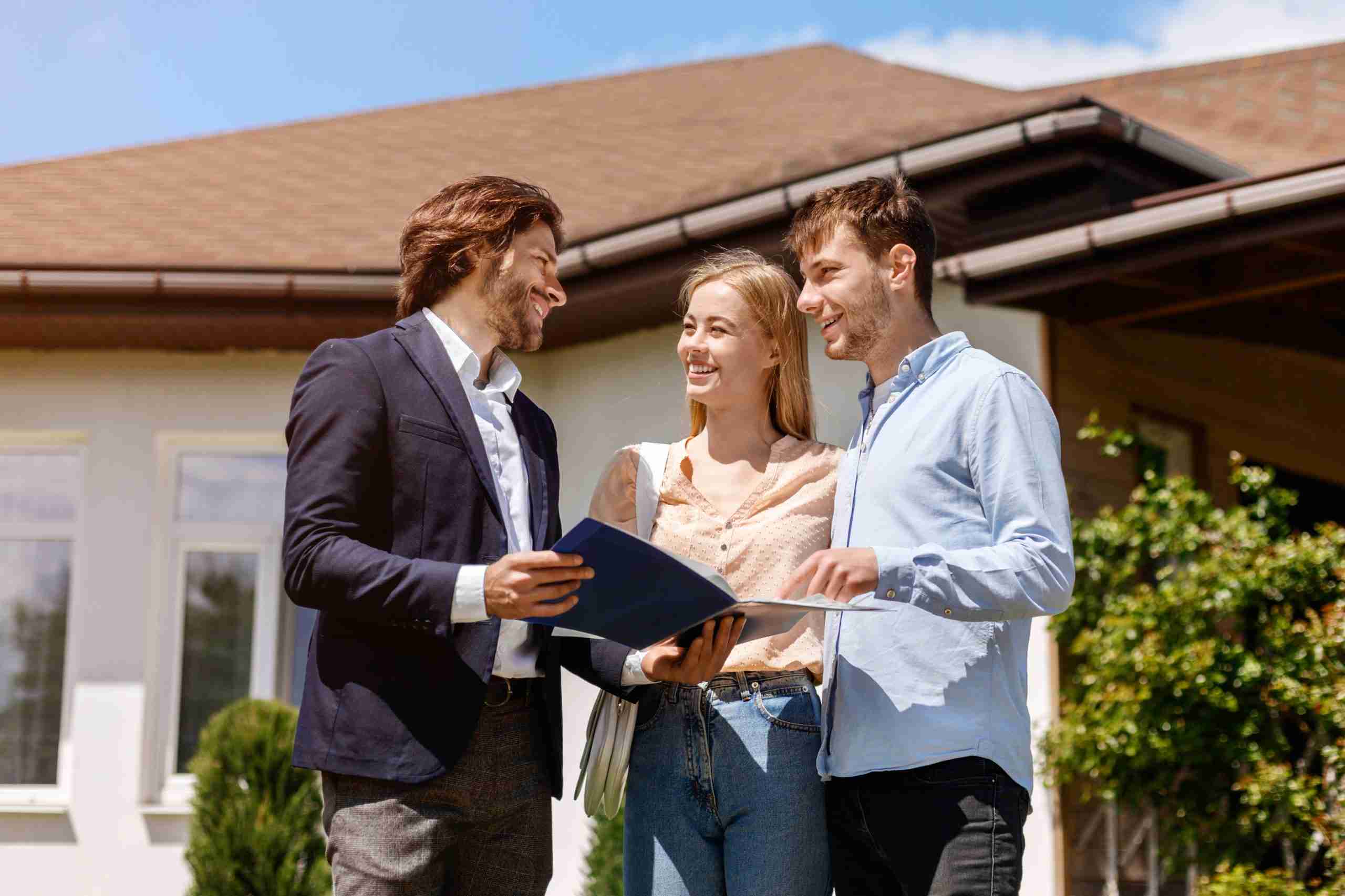 Real estate agent showing home rental or purchase contract to his customers in house backyard
