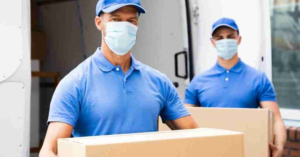 Two Charlotte to Columbus movers carrying boxes